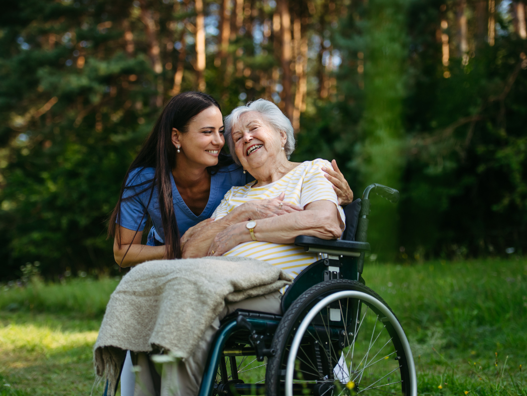 Participant and support worker enjoying time together outdoors in the community